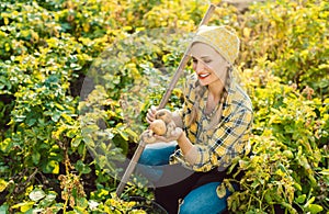 Farmer woman with freshly harvested potatoes