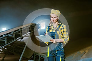 Farmer woman in the granary keeping track of the harvest