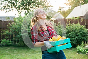 Farmer woman holding wooden box full of fresh raw vegetables copy space. Basket with vegetable cabbage, carrots