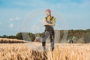 Farmer woman monitoring business progress of the harvest