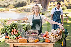 Farmer woman presenting a table of local food