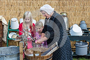 Farmer woman shows the use of a traditional washhub during a Dutch agricultural festiva