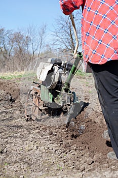 Farmer working with   cultivator