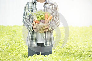 Farmers asian man hands with freshly harvested vegetables in basket,Concept of biological, bio products, bio ecology, grown by