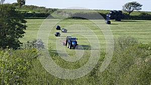 Farmers bailing hay