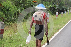 Farmers come home from the fields with hoes and bottles of drinking water