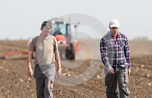 Farmers examing planted wheat fields photo