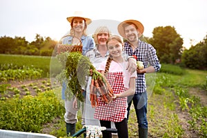 Farmers family with organic vegetables