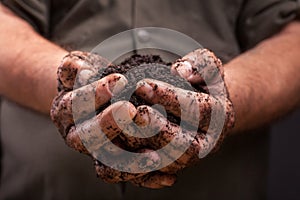 Farmers hand holding soil surface