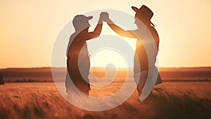 Farmers handshake a success silhouette in wheat field. Agriculture business concept. Farmers contract handshake success