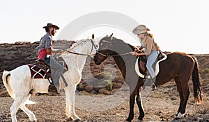Farmers having fun riding a horses in corral ranch