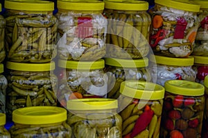 Farmers market in Bursa Turkey selling homemade pickles olive oil herbs close up view