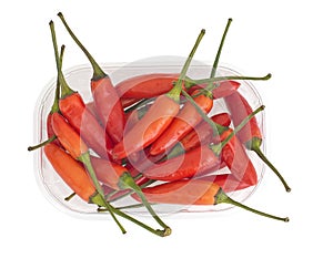 Farmers market chili peppers in punnet, isolated on white.