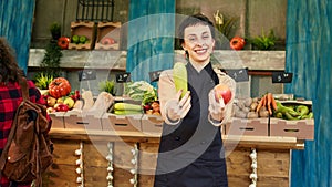 Farmers market seller holding natural grown products to customers