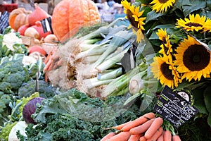 Farmers market stall provence France with vegetables and sunflowers.