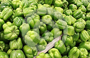 Farmers market table covered in fresh green peppers