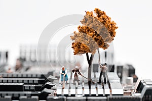 Farmers planting a tree on circuit board. Electronic waste recycling concept