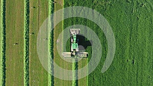 Farmers Tractor Mowing Fresh Green Fresh Grass For Hay Or Feed Aerial Top View