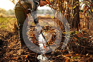 Farmers use a hoe to dig a ditch for farming