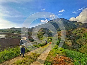 Farmers who are going to the fields on the slopes of Mount Sumbing