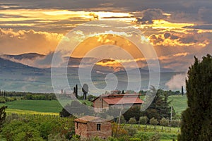 Farmhouse with garden in a scenic sunset landscape