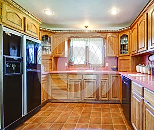 Farmhouse kitchen room with wood cabinets and pink backsplash