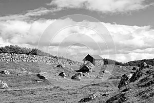 Farmhouse in Torshavn, Denmark. Old stone house in farm yard on cloudy blue sky. Typical rural architecture. Nature and