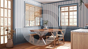 Farmhouse wooden dining room in white and blue tones. Cabinets and table with chair and bench. Wallpaper and parquet floor. Rustic