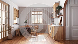 Farmhouse wooden kitchen with dining room in white and beige tones. Cabinets and table with chair. Wallpaper and parquet floor.
