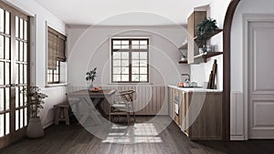 Farmhouse wooden kitchen with dining room in white and dark tones. Cabinets and table with chair. Parquet floor. Japandi interior