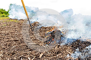 Cornfield fire with corn stover and trash burning in farm field.