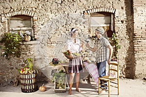 Farming couple making a toast with a glass of wine