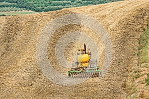 Farming with tractor and plow in field