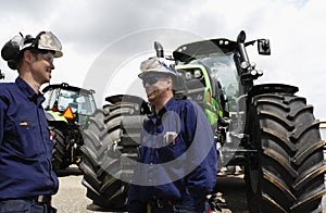 Farming tractors with two mechanics