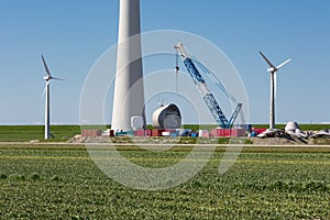 Farmland with construction work at the biggest windfarm of the Netherlands