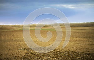 Farmland in early spring with a field ready to be sown photo