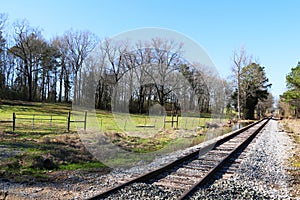 farmland gravel road crossing empty rural train tracks transportation railway countryside transport rails horizon