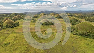 Farmland surrounds a cluster of the famous chocolate Hills in the sleepy town of Sagbayan, Bohol