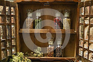 Vintage Wooden Spice Rack or Storage Cabinet and six glass bottles