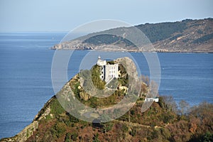 The Faro de la Plata Llighthouse and Cantabrian Sea. Monte Ulia, Pasaia, Gipuzkoa, Basque country, Spain photo