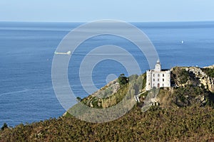 The Faro de la Plata Llighthouse and Cantabrian Sea. Monte Ulia, Pasaia, Gipuzkoa, Basque country, Spain photo