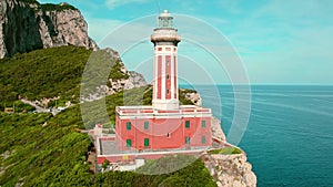 Faro di Punta Carena historic lighthouse on a rugged cliff on the island of Capri. Iconic structure serves as a