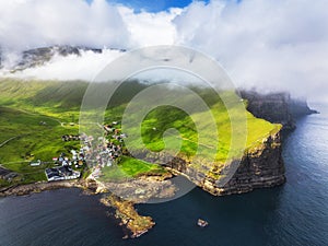 Faroe islands - Aerial panoramic view of the village of gjogv on cliffs washed by the ocean, Eysturoy island, Denmark, Europe photo