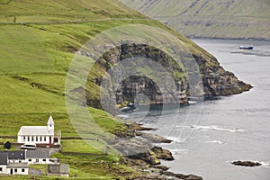 Faroe islands cliffs fjord coastline. Vidareidi village in Vidoy