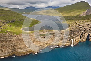 Faroe islands dramatic coastline in Vagar. Leitisvatn lake