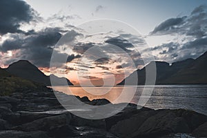 Faroe Islands Kalsoy in sunset light durig twilight with pink sky and cliffs.