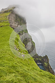 Faroe islands landscape with cliffs and atlantic ocean. Mikladalur, Kalsoy photo