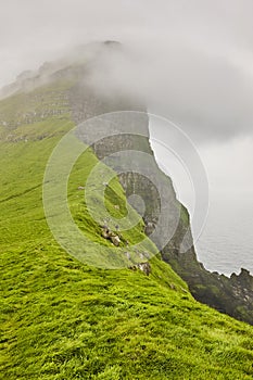 Faroe islands landscape with cliffs and atlantic ocean. Mikladalur, Kalsoy photo