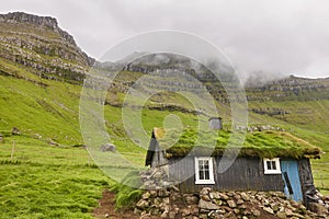 Faroe islands valley and traditional green roof house. Mikladalur, Kalsoy photo