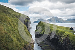 Faroe islands village of Gjogv or Gjov in Danish. Sea-filled gorge on the northeast tip of the island of Eysturoy, in